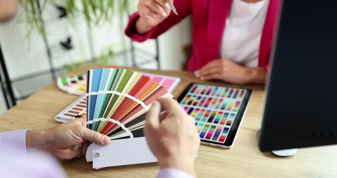 A man in the office chooses a color from a palette