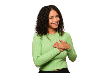 Young african american curly woman isolated has friendly expression, pressing palm to chest. Love...