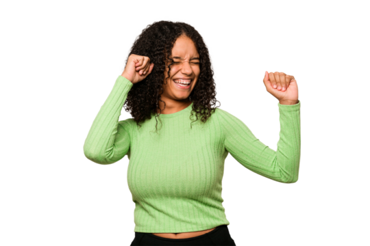 Young african american curly woman isolated dancing and having fun.