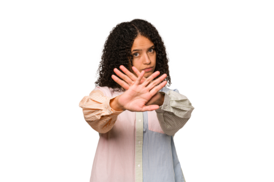 Young african american curly woman isolated doing a denial gesture