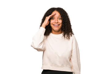 Young african american curly woman isolated shouts loud, keeps eyes opened and hands tense.