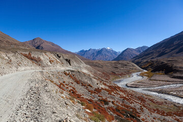 Road in Zanskar valley, Ladakh near Padum. Moto travel in India. Beautiful remote road and snowy mountain peaks.