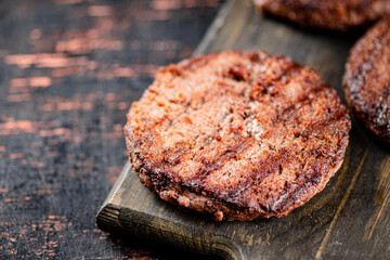 Burger grill on a wooden cutting board. 