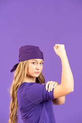 Portrait of strong feminist activist woman isolated on purple background. Equality and woman power concept