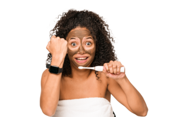 Young african american woman preparing to go out for dinner brushing her teeth looking at the time on the clock
