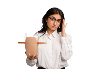 Young business indian woman eating takeaway noodles cut out isolated pointing temple with finger, thinking, focused on a task.