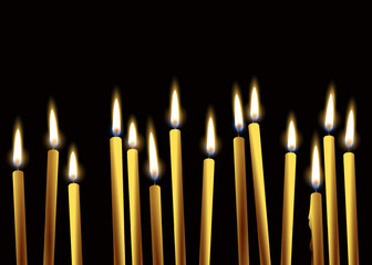 burning candles on a black background