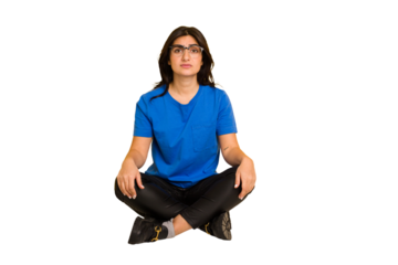 Young indian woman sitting on the floor cut out isolated sad, serious face, feeling miserable and displeased.