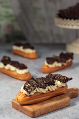 Toasted meringue-topped éclairs, their golden peaks adding a touch of drama to the smooth pastry beneath.