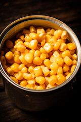 An open can of canned corn. 