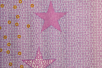 Macro photo of stars on a 500 euro banknote.