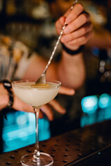 man hand bartender making cocktail in glass on the bar counter