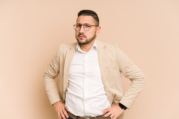Adult latin business man cut out isolated frowning face in displeasure, keeps arms folded.