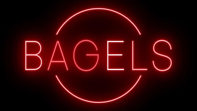 Retro red neon sign against a black wall with BAGELS