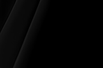 Part of the dark fabric texture of the fabric for the background and decoration of the work of art, a beautiful crumpled pattern of silk. A crumpled piece of cloth