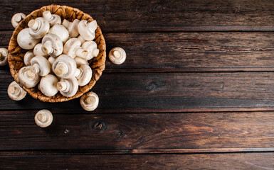 Fototapeta na wymiar Basket with fresh mushrooms. On a wooden background. 
