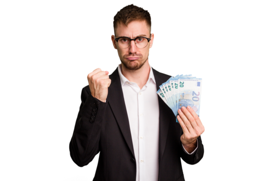 Young business caucasian man holding euro banknotes isolated cut out showing fist to camera, aggressive facial expression.