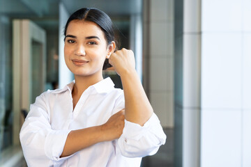 Fototapeta premium Strong and confident south asian woman in urban indoor building