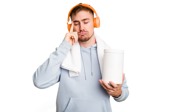 Young fitness man listening to music and holding a protein bottle isolated cut out pointing temple with finger, thinking, focused on a task.