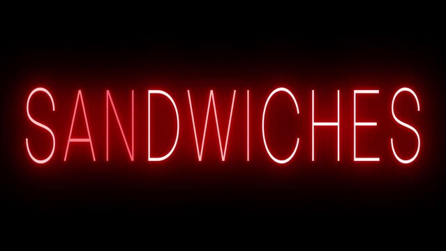 Retro red neon sign against a black wall with SANDWICHES