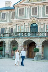 Beautiful young couple in love near the old palace. Wedding. Relationship.