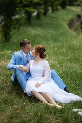 bride in a light wedding dress to the groom in a blue suit