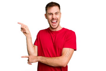 Young caucasian man cut out isolated pointing with forefingers to a copy space, expressing excitement and desire.