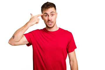 Young caucasian man cut out isolated showing a disappointment gesture with forefinger.