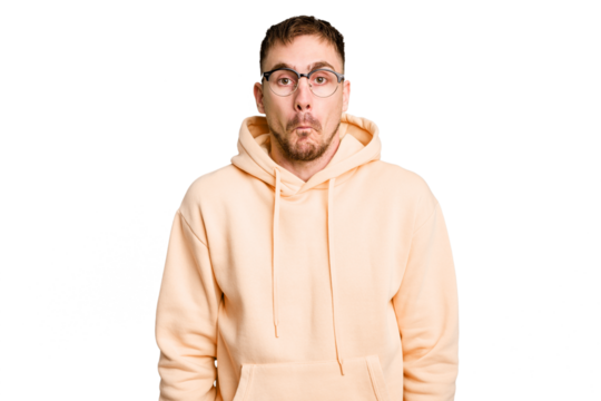 Young caucasian man cut out isolated shrugs shoulders and open eyes confused.