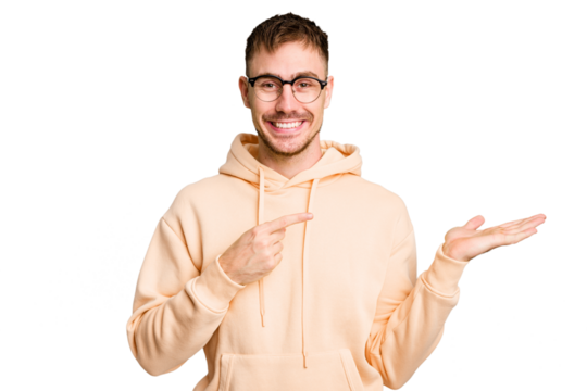 Young caucasian man cut out isolated excited holding a copy space on palm.