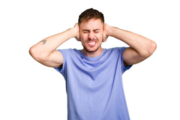 Young caucasian man cut out isolated covering ears with hands.