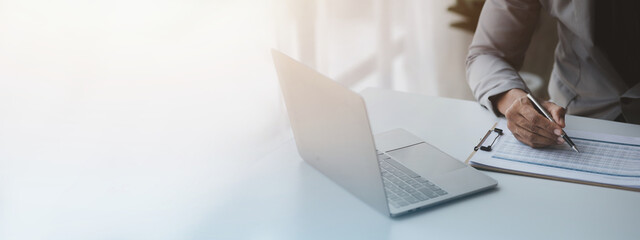 Business men are looking at the company's financial documents to analyze problems and find solutions before bringing the information to a meeting with a partner. Financial concept.