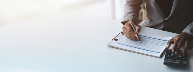 Business men are looking at the company's financial documents to analyze problems and find...