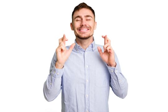 Young caucasian man cut out isolated crossing fingers for having luck - Powered by Adobe