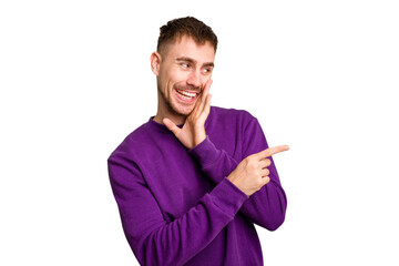 Young caucasian man cut out isolated saying a gossip, pointing to side reporting something.