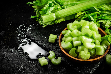 Pieces of fresh celery in a wooden plate. 