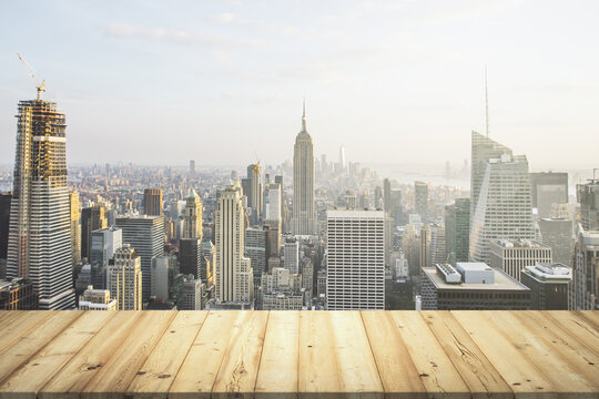 Wooden table top with beautiful New York skyline on background, mockup