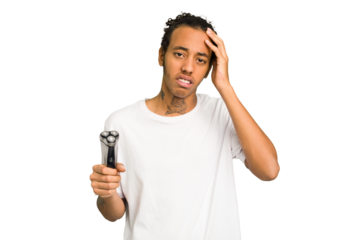Young African American man holding a razor isolated being shocked, she has remembered important meeting.