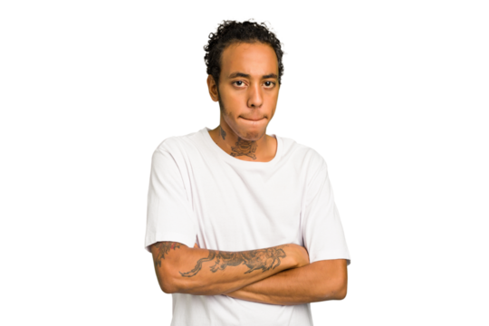 Young African American man isolated frowning face in displeasure, keeps arms folded.