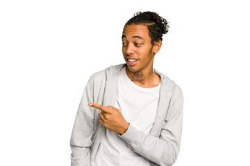 Young African American man isolated points with thumb finger away, laughing and carefree.