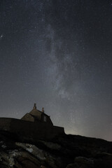 Winter Milky Way rising above a coastal boat house