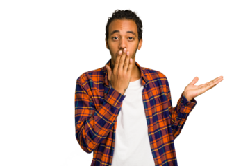 Young African American man isolated impressed holding copy space on palm.