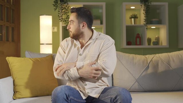 The mentally ill man begins to protect himself at home.
The schizophrenic patient is sitting alone at home, hallucinating and afraid.
