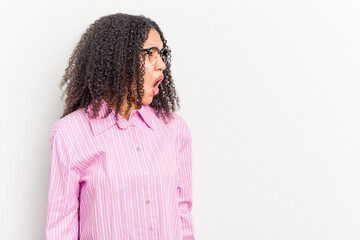 Young african american woman isolated on white background shouting very angry, rage concept, frustrated.