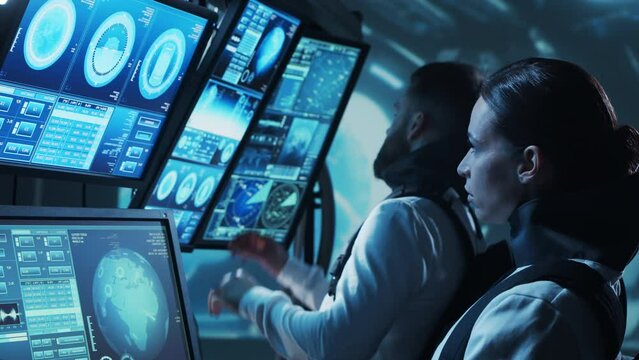 Team of astronauts in a space suits aboard the orbital station. A crew of cosmonauts piloting the spaceship. Man and woman in space. Galactic travel and science concept.