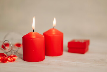 Beautiful composition with red candles on the white wooden table. Romantic love image