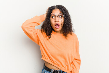 Young african american woman isolated on white background being shocked, she has remembered important meeting.