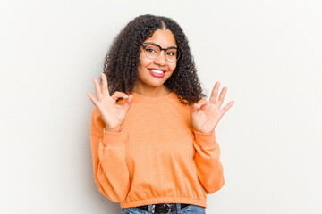 Young african american woman isolated on white background cheerful and confident showing ok gesture.