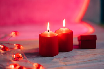 Beautiful composition with red candles on the white wooden table. Romantic love image