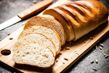 Sliced fresh wheat bread on a cutting board. 